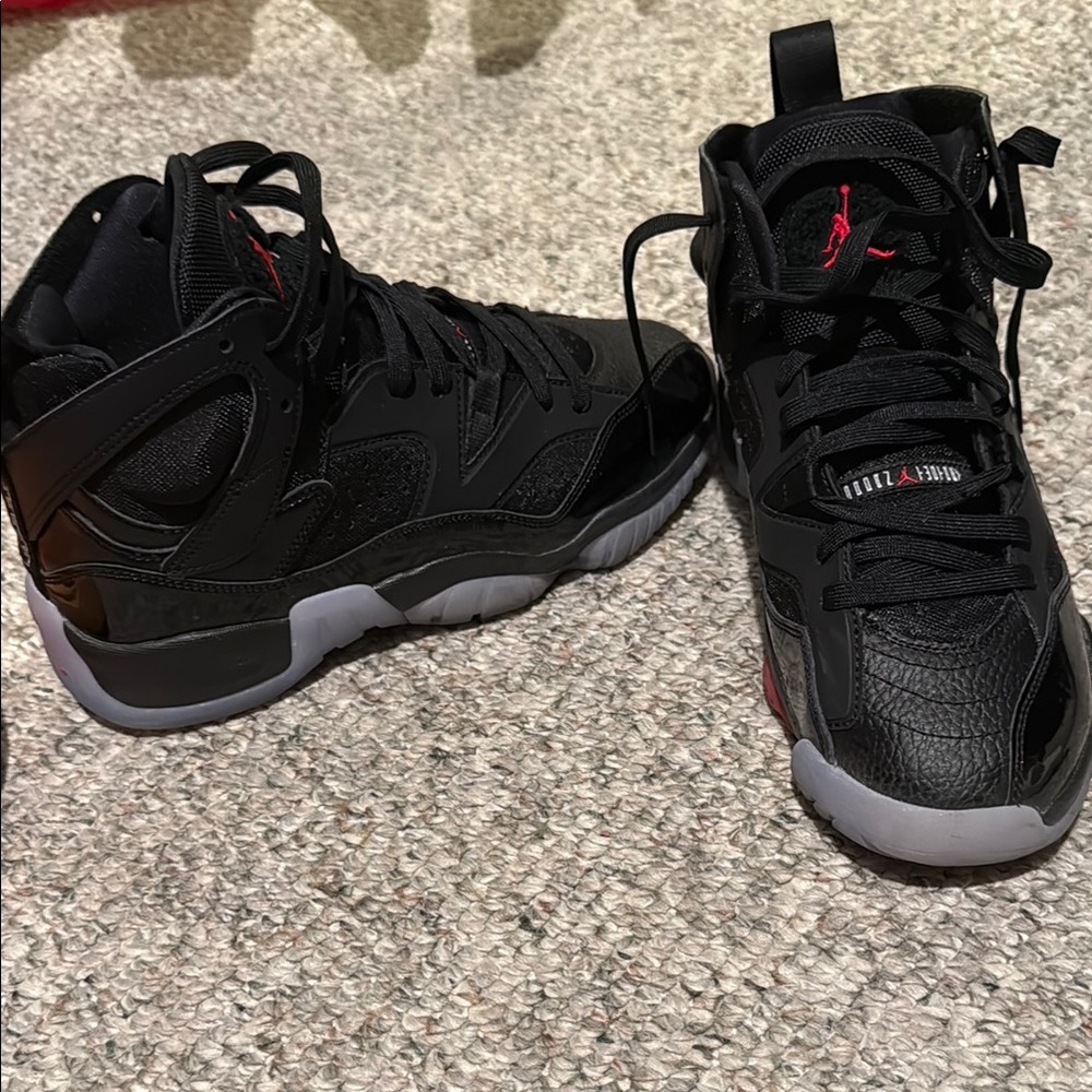 Jordan Sneakers in Black and Red with High-Top Design and Textured Material
